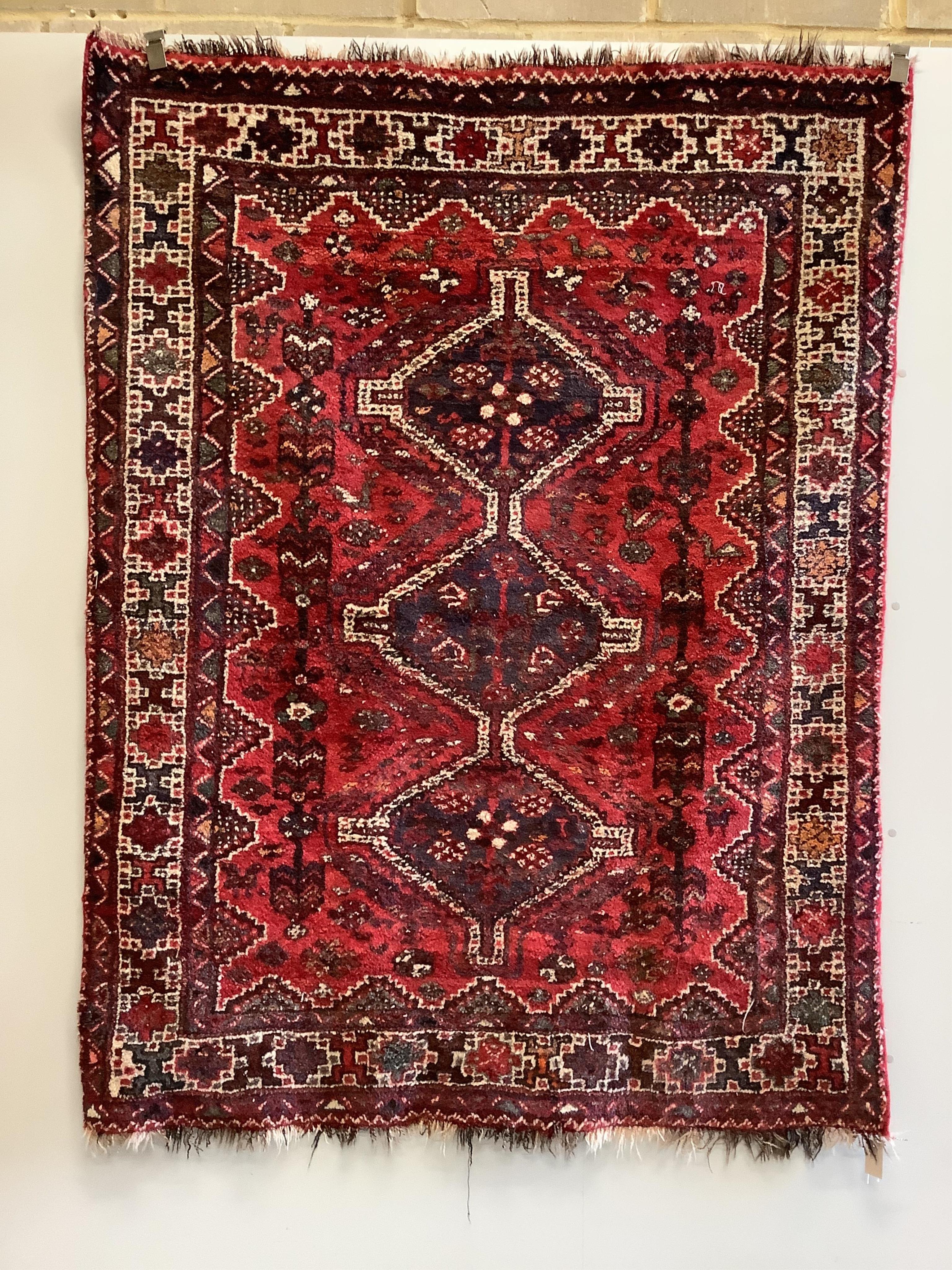 A Shiraz red ground rug, 200 x 157cm. Condition - fair